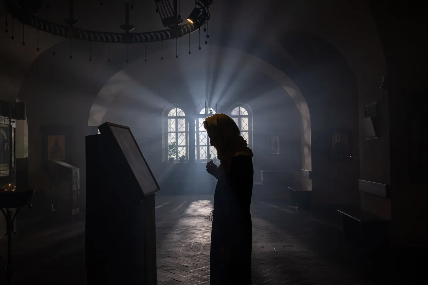 A woman praying quietly inside an Orthodox church